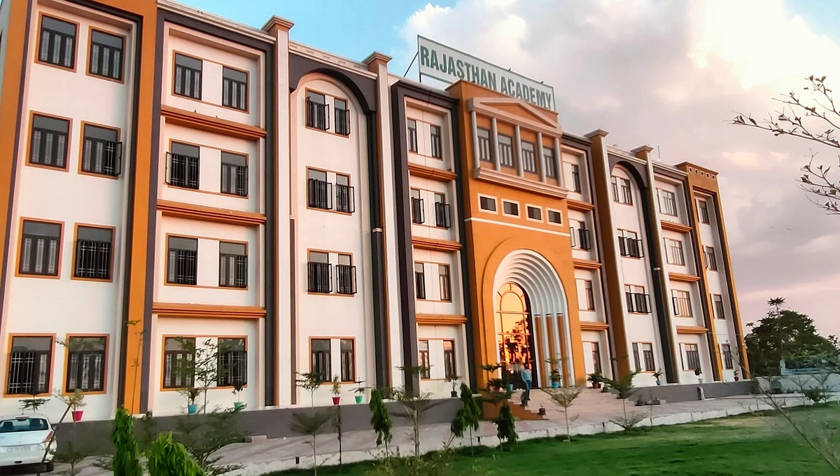 this is an image of a building of a coaching institute. The colour is cream and orange.